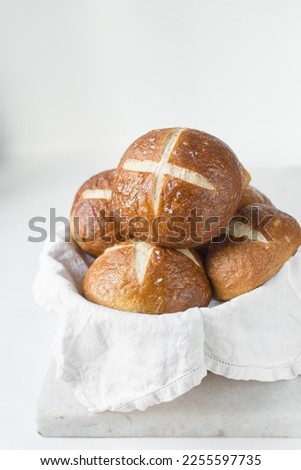 Pretzel buns in a napkin lined basket, German laugenbroetchen, lye buns in a basket
