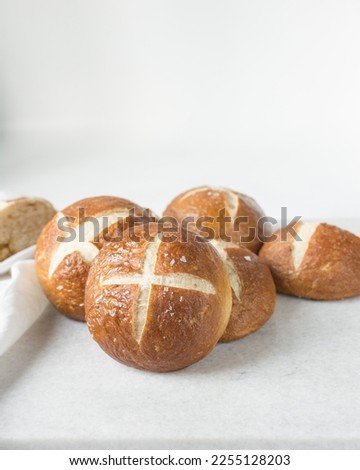 Pretzel buns on a marble tray, German laugenbroetchen, lye buns on a marble tray