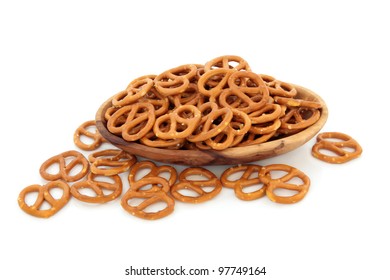 Pretzel Cracker Biscuits In An Olive Wood Bowl And Scattered Isolated Over White Background.