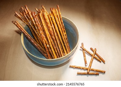 Pretzel Sticks In A Bowl On A Wooden Table, Crunchy Salt Snack, Typical Served In The Evening, In Pubs, On A Party Or At Home While Watching TV, Copy Space, Selected Focus, Narrow Depth Of Field