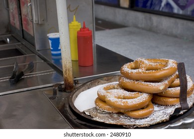 Pretzel Vendor Cart In New York City With Salted Pretzels In Foreground