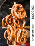 Pretzels - traditional german snacks are hanging on the wooden stand