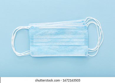 Prevent coronavirus. Medical mask, Medical protective mask isolated on blue background. Disposable surgical face mask cover mouth and nose. Healthcare medical Coronavirus quarantine, hygiene concept - Shutterstock ID 1672163503