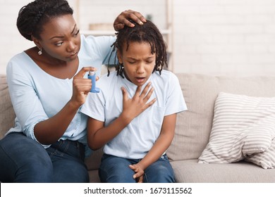 Preventing Attack. Black Woman Giving Blue Asthma Inhaler To Her Sick Breathless Child At Home, Free Space