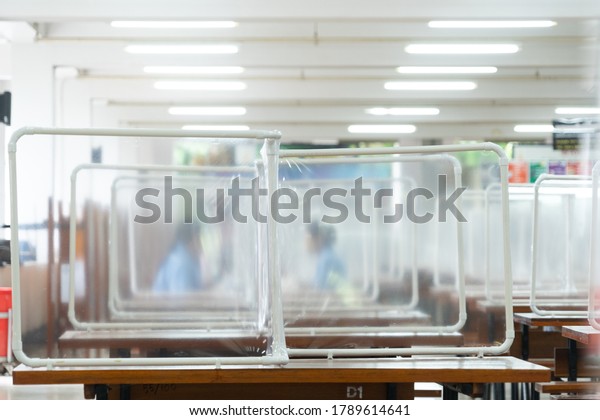 Preventing the spread of Covid-19 coronavirus in
schools and universities by using plastic sheets divide the area in
the cafeteria for social distance and new normal life policy in
Thailand