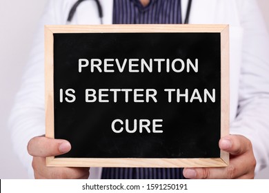 Prevention Is Better Than Cure. Male Doctor Holds Chalkboard With Health Typography Quotes Written On It. Health And Medical Concept