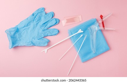 Preventive Gynecological Examination. Prevention For Womens Health. Basic Set For Vaginal Examination On Pink Background. Gynecological Speculum,  Gloves, Diaper And Shoe Covers. Female Health Concept