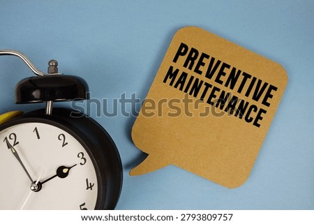 Preventive Maintenance text with alarm clock on blue background