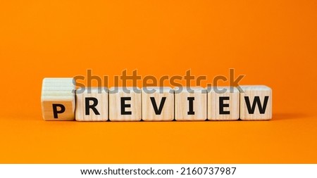 Preview or review symbol. Turned the cube and changed the word 'preview' to 'review'. Beautiful orange background, copy space. Business, preview or review concept.