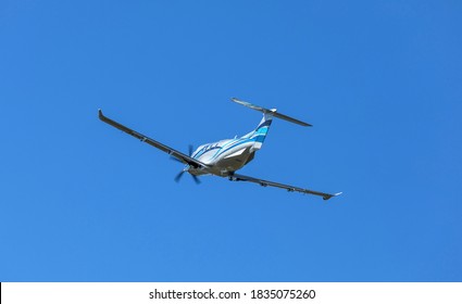 PRIBRAM, CZECH REPUBLIC - 1 October 2019. The Pilatus PC-12 NG single turboprop aircraft flies in the blue sky. The plane leaves from a small airport.