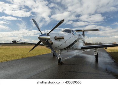 Pribram, CZECH REPUBLIC - 24th February 2016. Single turboprop aircraft PILATUS PC-12 NG white modern design with stripes, parked on runway with clouds.