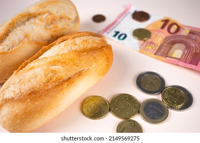 Price of bread, white bread loaf with euro money and coins. Expensive food because of inflation, prices raise and food crisis. - Shutterstock ID 2149569275