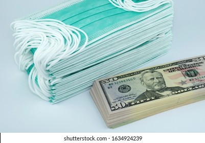 Price gouging during shortage of virus masks. High price of masks and demand during quarantine in United States, Europe and global pandemic. Pile of anti virus surgical face masks and money. Concept.