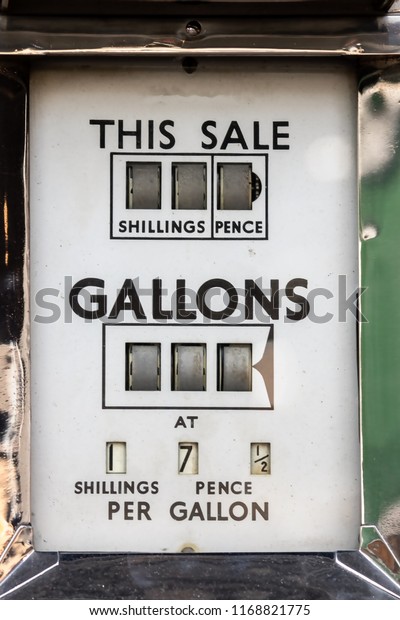 Price of petrol. Vintage car fuel pump meter with\
gallons priced in shillings and pence. Retro gasoline station.\
Antique gas dispenser. inflation in the crude oil and petroleum\
industry. Fuel crisis.