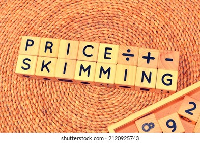 PRICE SKIMMING Word Text From Wooden Cube Block Letters. Price Skimming Involves Initially Charging The Highest Price Your Market Will Accept For Your Product, Then Lowering It Over Time.