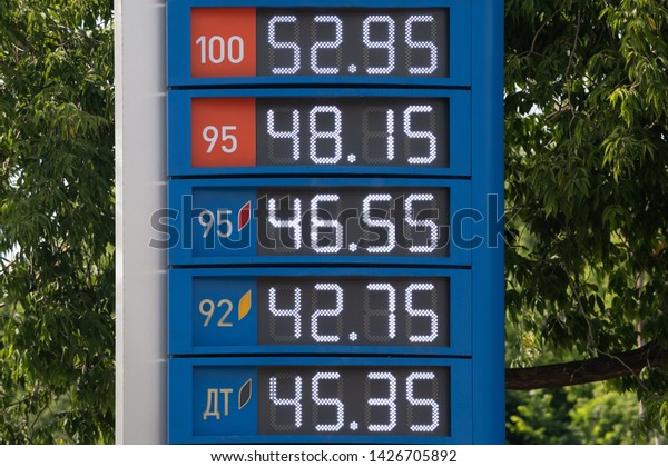 Prices on the\
information board of the petrol station. Numbers on the metal\
surface with mechanically movable covers. Cyrillic inscription:\
Diesel Fuel and Gas.
