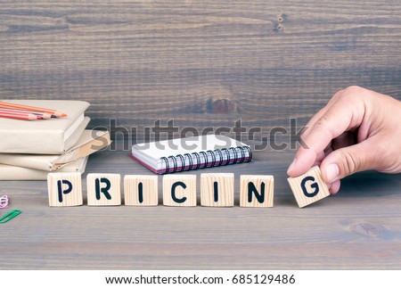 pricing. Wooden letters on dark background