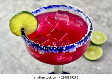 Prickly pear margarita over ice with lime garnish