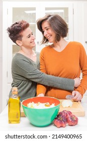 Pride Day. LGBTQ+ Couple In Their Daily Live. Casual Lesbian Couple Cooking At Home. 