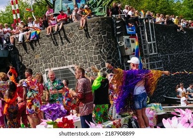 Pride Parade Of Lesbian, Gay, Bisexual, Transgender, Queer And Allies. LGBTQ People In Colorful Costumes Dancing, Smiling, Having Fun - Netherlands, Amsterdam, August 6, 2022.