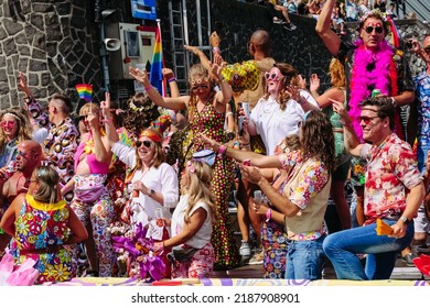 Pride Parade Of Lesbian, Gay, Bisexual, Transgender, Queer And Allies. LGBTQ People In Colorful Costumes Dancing, Smiling, Having Fun - Netherlands, Amsterdam, August 6, 2022.