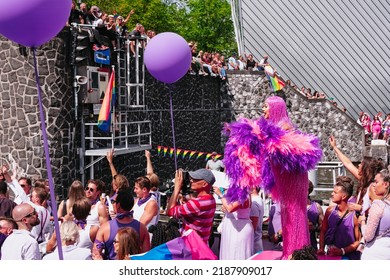 Pride Parade Of Lesbian, Gay, Bisexual, Transgender, Queer And Allies. LGBTQ Participate In Canal Parade, People In Colorful Costumes Dancing, Smiling - Netherlands, Amsterdam, August 6, 2022.