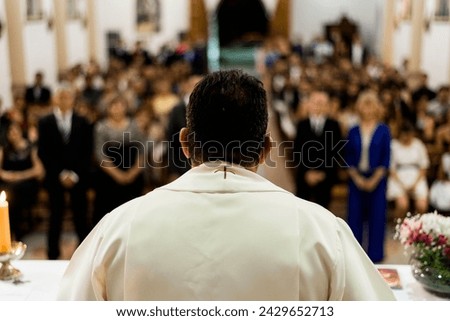 priest at altar giving mass in his church