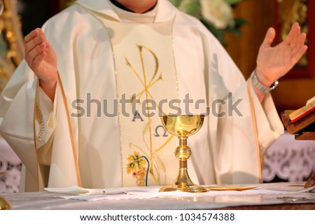 Priest celebrate mass at the church and empty place for text

