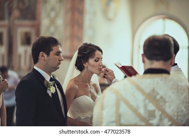 the priest give ring to young bride