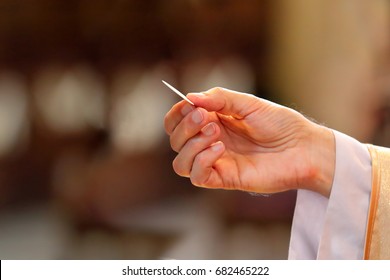 Priest gives holy communion to faithful and empty space for text - Shutterstock ID 682465222