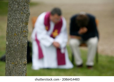 Priest giving Holy confession outside.  France.  - Shutterstock ID 2086414483