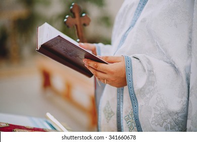 Priest Holding A Bible