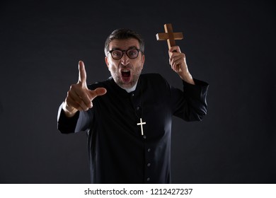 Priest Holding Cross Of Wood Praying And Shouting