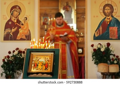 Priest In Orthodox Church. Church Service On A Public Holiday. Easter Holiday Concept. Priest Reads Prayer In Temple. 