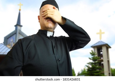 priest in the parish covers his eyes