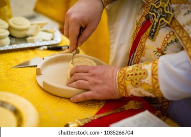 The Priest Prepare For Communion Orthodox Christians, The Hand Of The Priest Cutting The Bread For Communion