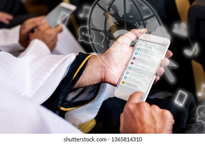 Priest Using His Mobile Phone