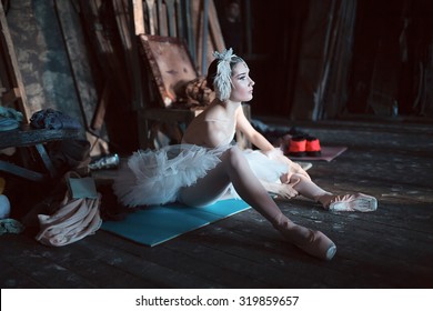 Prima ballerina sitting on the warm-up backstage before going on stage for a solo program on the stage in a performance of Swan Lake, view the profile. Repetition. - Powered by Shutterstock