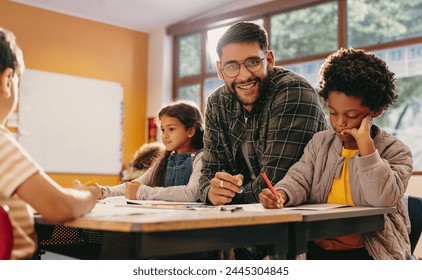 Primary educator smiling at the camera in a classroom. Teacher teaching a group of children in a school. Man giving an art lesson in an early child development centre. - Powered by Shutterstock