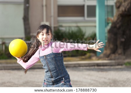 Primary Japanese girl playing dodge ball