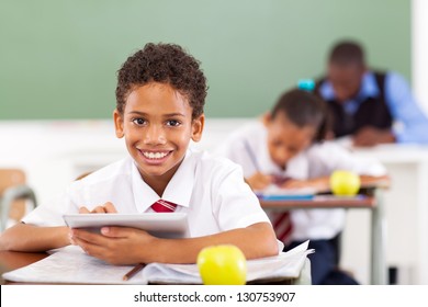 Primary School Boy Using Tablet Compute In Classroom