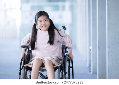 Primary school girl in wheelchair in school. Image of a schoolchild using a wheelchair due to injury or other reasons. - Powered by Shutterstock