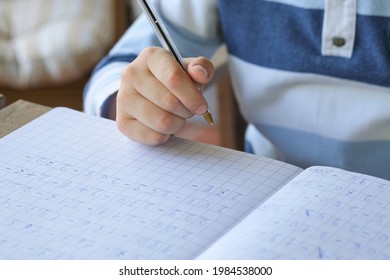 Primary school kid hand while doing maths homework writing,excercise education lifestyle