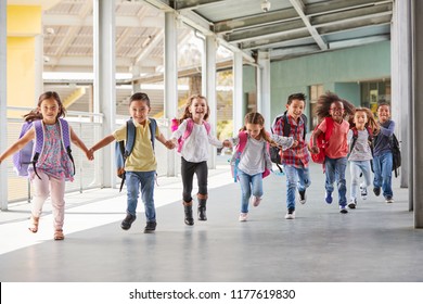 Primary School Kids Run Holding Hands In Corridor, Close Up