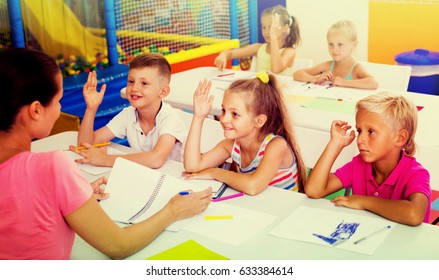primary school kids sitting at school class and listening to a teacher at lesson  - Shutterstock ID 633384614