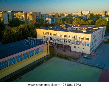 A primary school in Poland located between apartment blocks built in the mid-20th century.