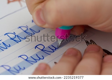 Primary school pupil learns to write