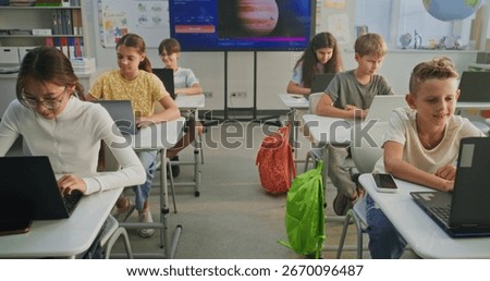 Primary School Students Working on Creative Projects on Laptops, Practicing Digital Skills in Art Class. Digital Screen Showing AI Software for Creating Pictures. Interactive STEM Learning. Dolly Shot
