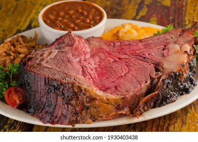 Prime Rib. Beef Prime Rib bbq. Beef rubbed in spices and seasoning and slow cooked in a smoke house with mesquite wood chips. Traditional barbecue Texas Smoke House beef prime rib.  - Shutterstock ID 1930403438