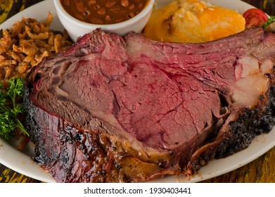 Prime Rib. Beef Prime Rib bbq. Beef rubbed in spices and seasoning and slow cooked in a smoke house with mesquite wood chips. Traditional barbecue Texas Smoke House beef prime rib.  - Shutterstock ID 1930403441